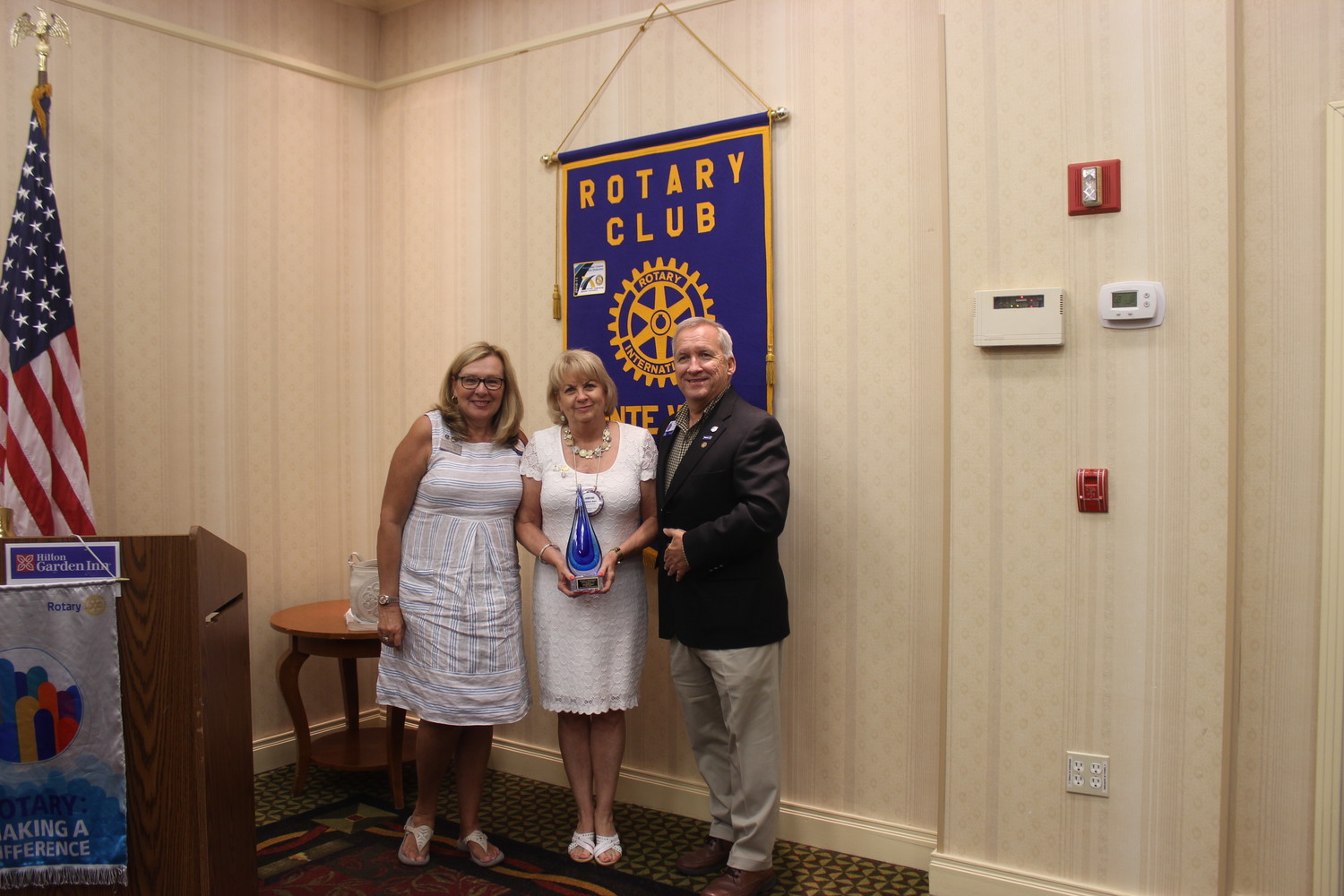 Rotary Club of Ponte Vedra Beach Sunset member Janeene Hart (center) receives the “Making a Difference” award from Club President Cyndi King and District 6970 Governor Brent Coates.